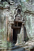 Ta Prohm temple - in sculpted frontons most of Buddha images have been erased 